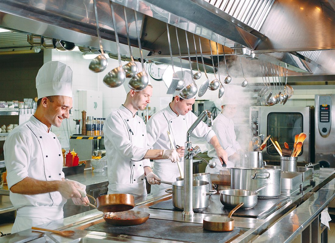 Business Insurance - Group of Chefs Working in a Kitchen Cooking