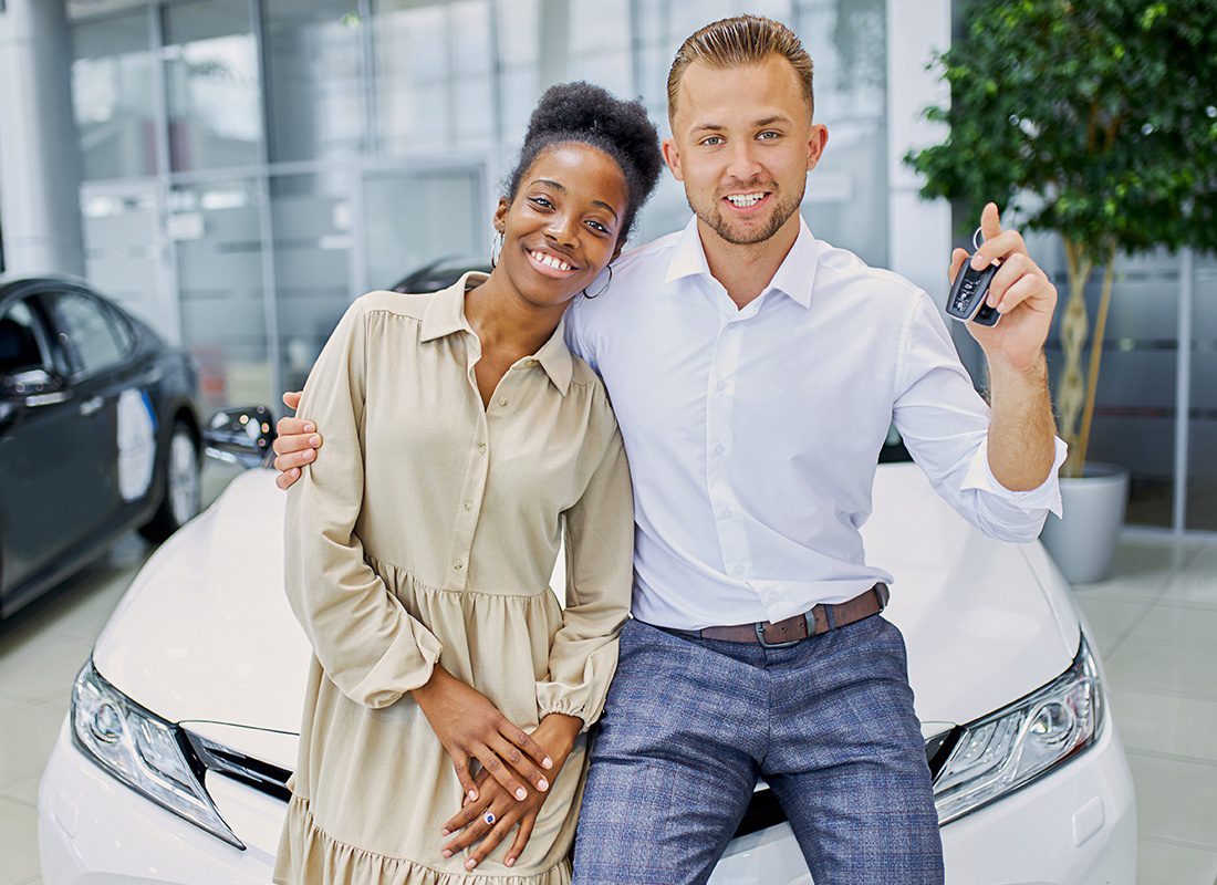 Personal Insurance - Man and Woman Standing in Front of Their New Car